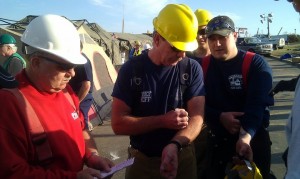 New Sharon Fire Chief Steve Gerard (left) and Oskaloosa Fire Chief Mark Neff (center) write important info on their arms before heading out on search and recovery in Joplin, Missouri (photo courtesty Montezuma Fire & Rescue)