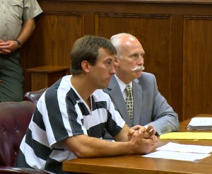 Jason Ebelsheiser sits in court with his attorney Leon Spies