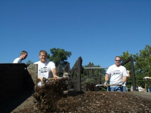 Brad Hannon and Nathan Johnson help load old mulch into a Musco truck so it can be hauled away.