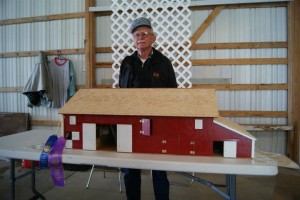 Henry Nunnikhoven is seen here standing with his finished replica barn he modeled by hand (photo D.Hubbard)