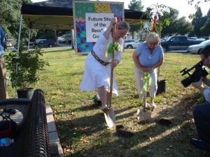 Oskaloosa Library Director Wanda Gardner and Youth Librarian Linda Fox take their turn at the ground breaking ceremony