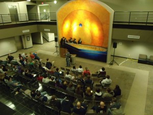Colin Beavan talks with those on hand to hear his story at the Musco Technology Center Wednesday evening
