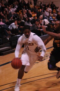 Alan Douglas drives against #24 Ashford in Penn's triple over time win Saturday