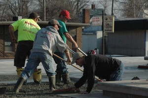 Paul Scanlon, (foreground using the trowel) and his crew finished pouring the last sections of cement before moving onto the next phase