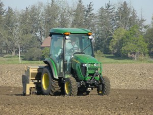 Martin Roepke seeding grass on the north side soccer fields