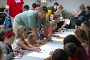 Mahaska County Naturalist Laura DeCook helps some younger Oskaloosa residents discover "Enormous Gigantic Animals"