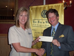 Keeping with their tradition of putting service above self, the Oskaloosa Rotary Club, represented by club president, Jill Brumbaugh, presents a check in the amount of $200 to Youth for Christ director Doug Mills. Contributions made weekly by club members for the Community Jar are accumulated and donated to local non-profit organizations.