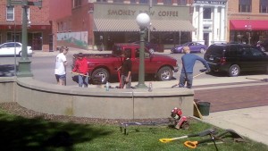 Members of the Mahaska County 4-H club Scott-U-Need-Us work on cleaning up and planting flowers Wednesday