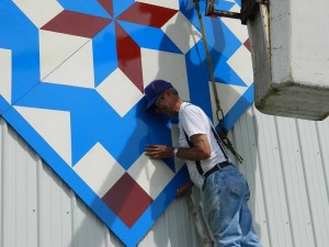 The new barn quilt being hung on the side of Bradbury Hall (photo submitted)