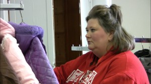 Tonya Rice attends coats donated to help others stay warm this winter.