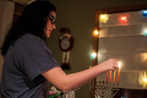 Mandi Vogel lights the family menorah during an evening of Hanukkah.