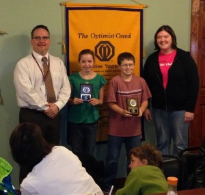 Sixth graders Kirby Nelson, second from left, and Josh Stoneberg were honored as Optimist Students o the Trimester. Pictured is middle school principal Andy Hotek and club president Andrea Brownlee. (submitted image)