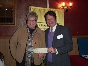Oskaloosa Rotary Club President, Doug Mills, presents Robin Pfalzgraf of Love in the Name of Christ with a $184.00 donation at the January 22 meeting. (submitted photo)