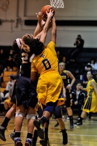 Orielle Thomas fights for the rebound against Clarke on Saturday.