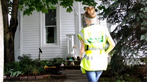 Mahaska CERT Team member Ariel LaRue delivers water to a New Sharon residence on Monday.