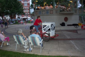 Lisa Tucker is riding the Cooler Bike handing out free lemonade and iced tea from a previous Oskaloosa Municipal Band Concert. (submitted photo)