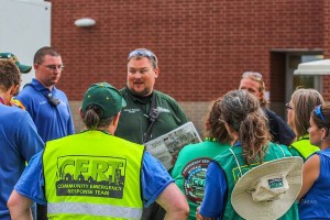 Mahaska County Emergency Manager Jamey Robinson is seen here briefing the CERT Team on Thursday during RAGBRAI (photo by Denis Currier)