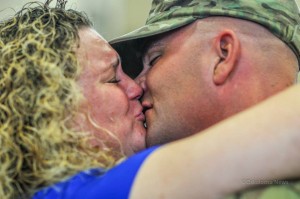 Amy Toubekis (left) and George Toubekis (right) share that first kiss in nearly a year on Saturday just moments after being released from active duty.