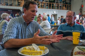     Rick Santorum visits with guests at the Steve Boender farm on Friday evening.