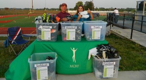 Kevin Peterson, Oskaloosa High School Athletic Director and Sherry Vavra, Director of Mahaska Community Recreation Foundation (MCRF), were flooded with donations toward the Play It Forward athletic equipment exchange program at the Old Shoe Game.