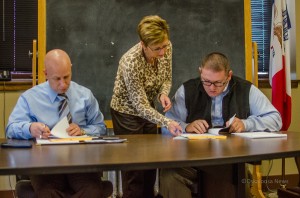 Mahaska County Supervisors Mike Vander Molen (left) and Mark Doland (right) along with Mahaska County Auditor Sue Brown (center) discuss the results of the city elections. Doland's wife participated as a candidate in Oskaloosa's 3rd Ward. All three voted to certify the election.
