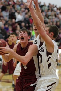 Ryan Reiter drives to the hoop on Friday night against Pella Christian (Photo by Denis Currier/Oskaloosa News)