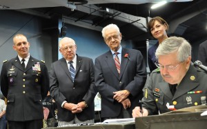 Iowa Governor Terry Branstad signs the Home Base Iowa Act into law at the Iowa Gold Star Military Museum at Camp Dodge in Johnston, Iowa. (photo by Iowa Governor’s Office)
