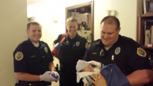 Officer Garrett Matson (right) is seen moments after helping deliver a baby.