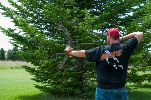 Logan Bogatzke draws his bow back and takes aim at a target Saturday.