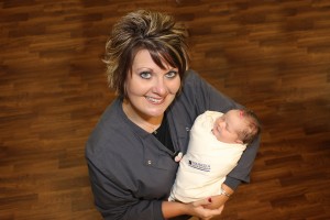  Mahaska Health Partnership Birthing Center Director Chyann Vroegh shows baby Avery wearing a sleep sack. Each baby born at MHP is gifted one of these special wearable blankets from Whispering Tree Gifts, operated by the Hospital Auxiliary on the MHP campus. (submitted photo)