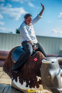 Chef Pam Oldes takes on the challenge of the mechanical bull at Sunday's Grand Opening.