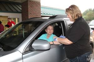 Nancy Engeman of Oskaloosa is one of 132 people to get a flu vaccination at the Drive-Thru Flu Clinic on Saturday, Sept. 20 at Mahaska Health Partnership. She is shown receiving her shot from MHP Public Health Nurse Patty Malloy. The clinic was sponsored by MHP Public Health. Walk-in Flu Vaccination Clinics are still available at Public Health (entrance #1) Mondays from 8:00 am  to Noon & Thursdays from 1:00 to 4:00 pm. Flu vaccines outside the scheduled clinics are available by appointment. Please call 641.673.3257. The flu shot and flu mist are $25. High dose vaccine for people 65 years and older is also available for $30. Medicare Plan B can be billed with proof of card. MHP Public Health also participates in the Vaccines for Children (VFC) program that provides flu vaccines to Medicaid, underinsured and uninsured children ages 6 months to 18 years old.