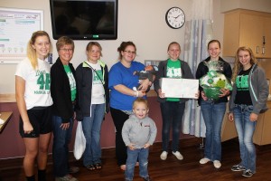 In honor of National 4-H Week, Mahaska County members wanted to give back to the community by presenting a gift to the first baby born at the MHP Birthing Center during National 4-H week. Mom, Courtney Garber of Deep River, holds Hunter while big brother, Tiegan, shares in the excitement. 4-H club members are, from left; Leah Van Mannen, 4-H leader Karen Adams, Lily Stream, Rachel Adams, Veronica Bolibaugh and Sienna DeJong.