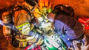     Oskaloosa emergency responders work to save the life of a family pet Tuesday night. They performed CPR and used oxygen in an attempt to revive the family dog.