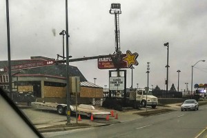 Crews worked at removing signage and boarding up windows at the Oskaloosa Hardees location on Monday.  The sign out front read, "Closed Thank You Osky" (photo by Tammy Kelderman