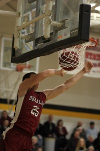 Sophomore Jack Moore finished off a fast break int he first quarter with a two-handed dunk that set the Indian crowd on fire. (photo by Denis Currier/Oskaloosa News)