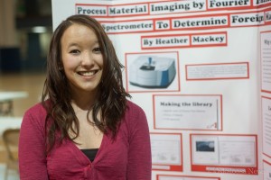 Heather Mackey stands next to the display at Tuesdays symposium.