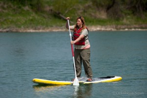 Warren County Naturalist Logan Roberts demonstrates how to use a paddleboard on Saturday.