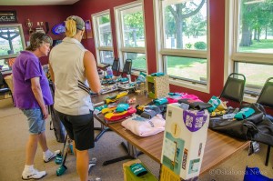 Participants of the Crisis Intervention Services Golf Tournament check out the prizes available.