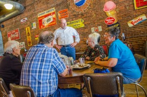 Congressman Dave Loebsack (standing) visits with Smokey Row patrons on Saturday afternoon.