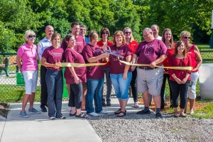 Dog Park Committee members cut the ribbon to official open the Oskaloosa Dog Park.