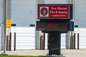 The lighted sign at the New Sharon Fire station simply read 'Pray'.