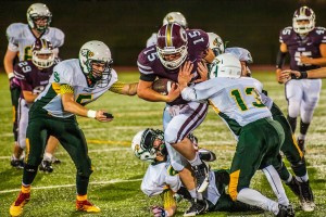 Oskaloosa Quarterback Ethan Arnold moves the ball down-field against the Saydel Eagles on Friday night.