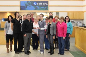 Bank Iowa President Daryl Petty presents a breast cancer donation to MHP Director of Radiology Julie Hartke as staff look on.