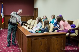 Mahaska County Deputy Sheriff Doug McMillan shows the 'evidence' he collected during his investigation to the jury of Girl Scouts.