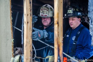 Oskaloosa Fire Chief Mark Neff (left) and firefighter Mark Tennison (right) work on investigating the cause of an early morning fire that damaged the Oskaloosa Pizza Hut.