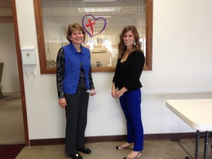 Oskaloosa Rotary member Valinn McReynolds presents Executive Director Debbie Howe of LOVE, Inc. with a donation from the Oskaloosa Rotary Club.