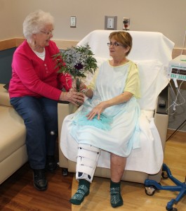 To celebrate National Patient Recognition Day on Feb. 2, patients received a purple carnation from Whispering Tree Gifts, located on the lower level of the new patient care wing, as well as a thank you card. Shown receiving her flower from Whispering Tree Gifts Volunteer Floral Designer Dorothy Vos is Carolyn Clay of Oskaloosa. 