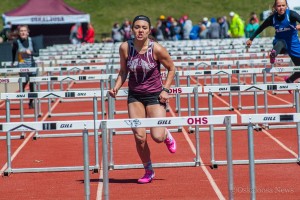 Maria Settimi is about to clear the final hurdle to cross the finish line for her team in the Shuttle Hurdle Relay on Saturday.