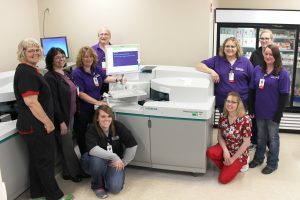 Mahaska Health Partnership Laboratory Services recently installed two Siemens Dimension EXL 200 and a Siemens Centaur XP Chemistry Analyzer. Pictured with some of the new instruments are, from left, Crystal Phillips, Krystal Thompson (kneeling), Janet Braden, Barb Fisher, Lab Director Tim Schroeder, Marcia Larson (kneeling), Beth Smith, Ashley Steffen and Leah Connelly.